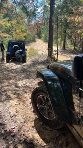 A jeep being winched out of a mud hole.